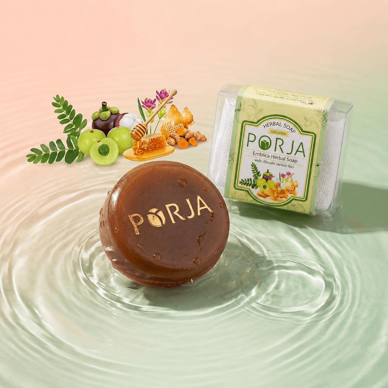 สบู่สมุนไพร PORJA Emblica Herbal Soap ก้อนสีน้ำตาลวางบนผิวน้ำ ล้อมด้วยมะขามป้อม ขมิ้น น้ำผึ้ง และมังคุด พร้อมกล่องบรรจุภัณฑ์